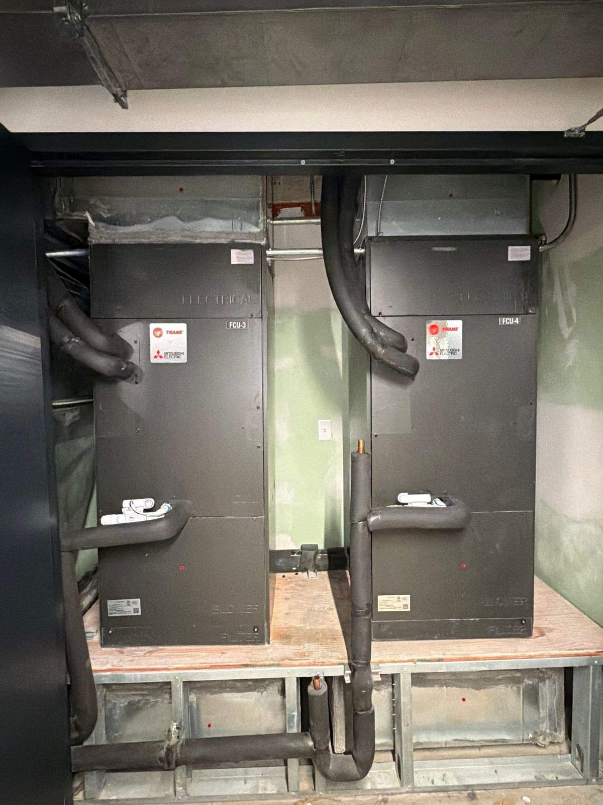 Two commercial air handlers on raised stands