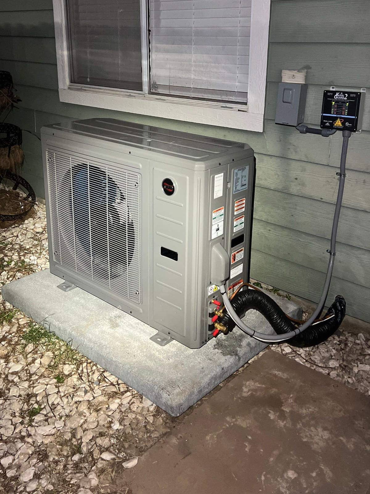 Ductless outdoor unit on a pad under a window