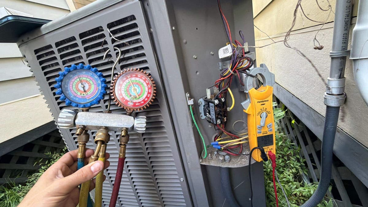 Gauges and a meter hooked to an outdoor AC unit