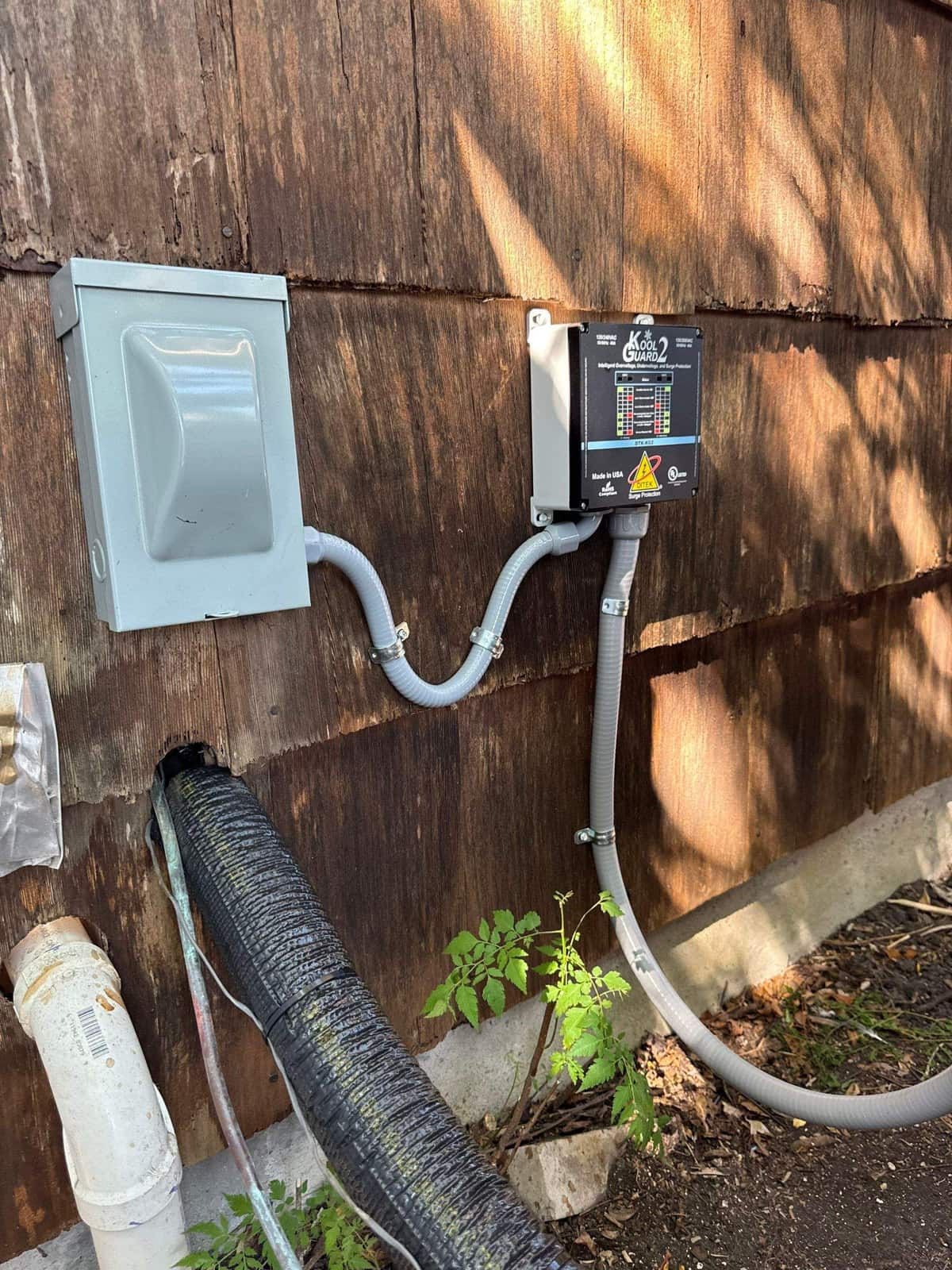 Surge protector wired in beside an AC disconnect