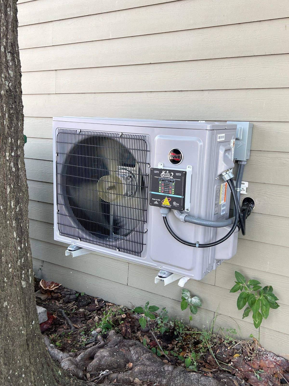 Ductless outdoor unit mounted on beige siding